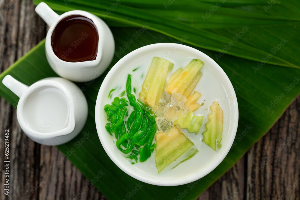 Top view of Lod Chong, fresh coconut milk, sugar cane decorated with pandan leaves followed by green