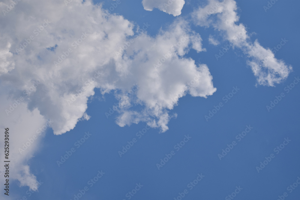 Bright white clouds over blue sky