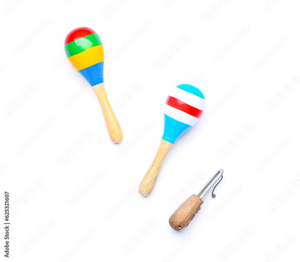 Jaw harp and maracas on white background