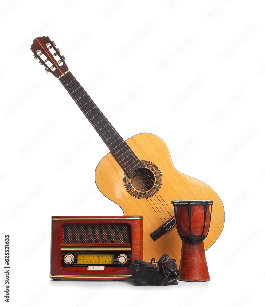 Different musical instruments and retro radio receiver on white background