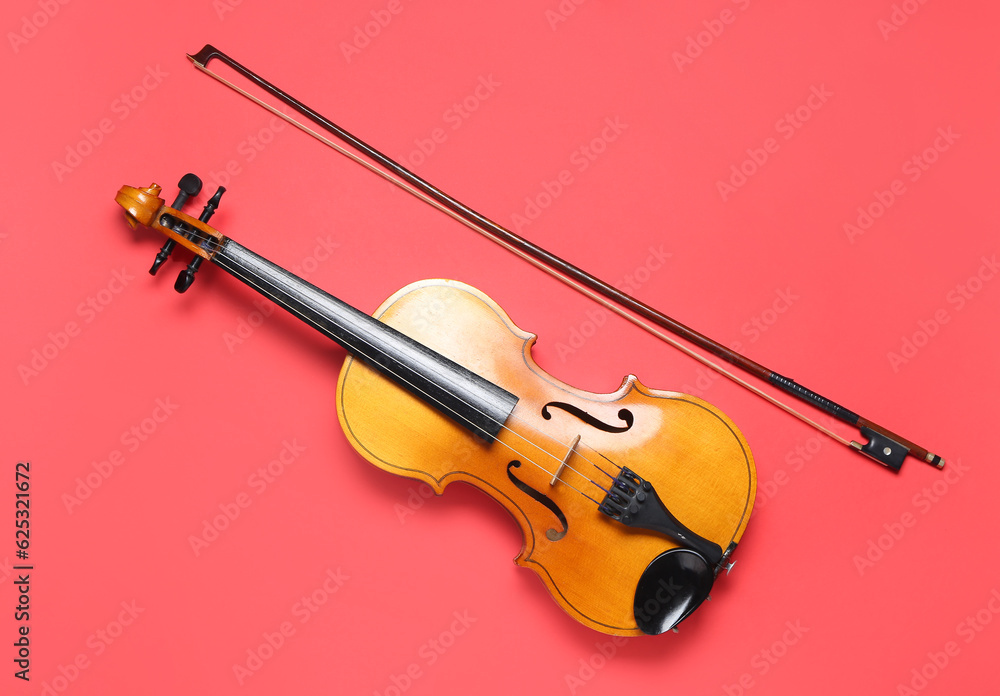 Beautiful violin with bow on color background