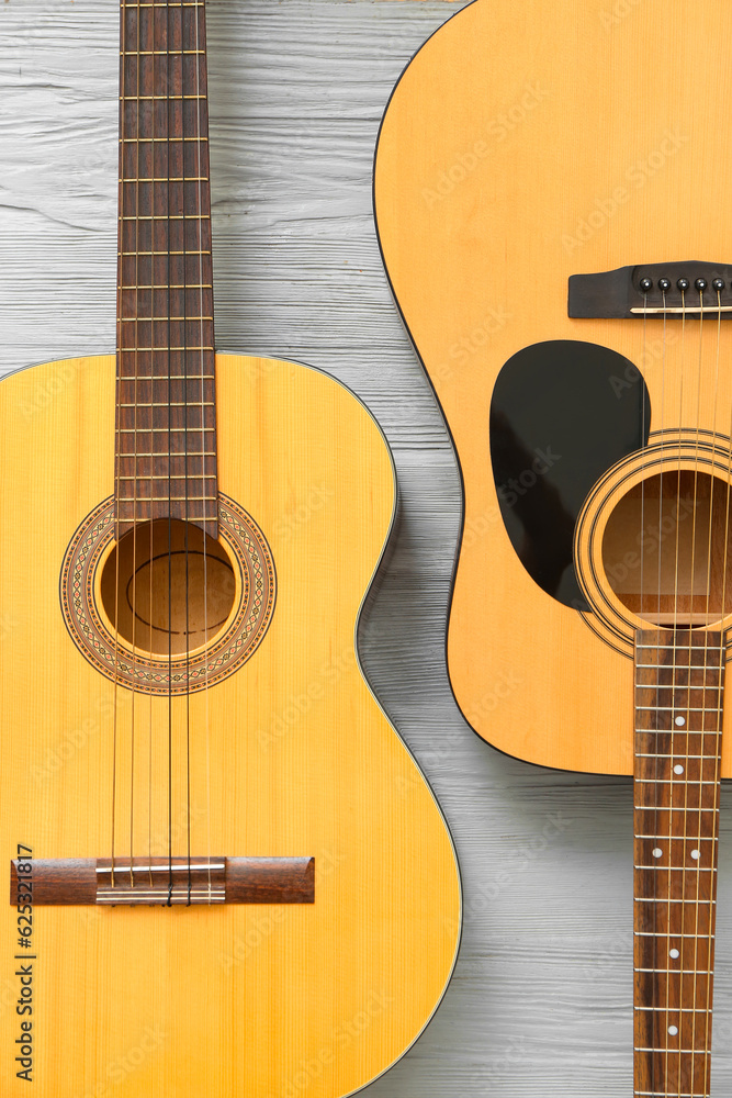 Acoustic guitars on wooden background, top view