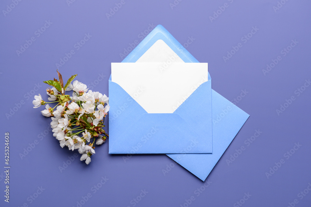 Envelopes with blank card and blooming tree branch on white background