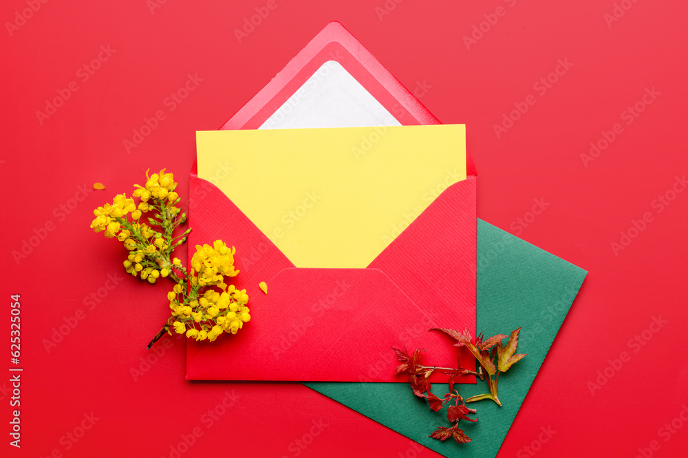 Composition with envelopes, blank card and blooming plant branches on color background