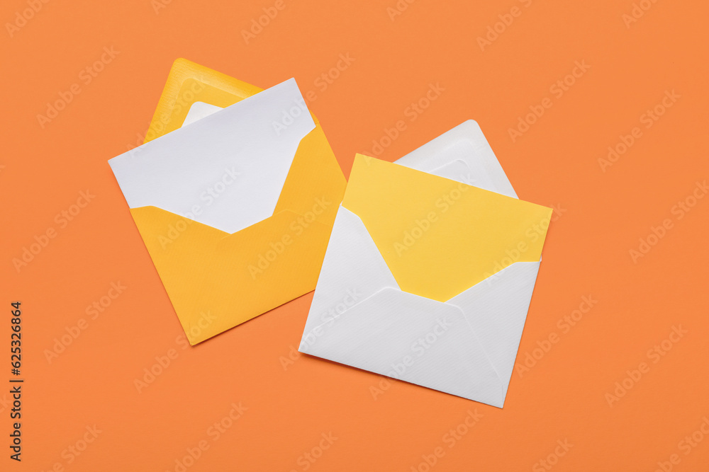 Paper envelopes with blank cards on color background