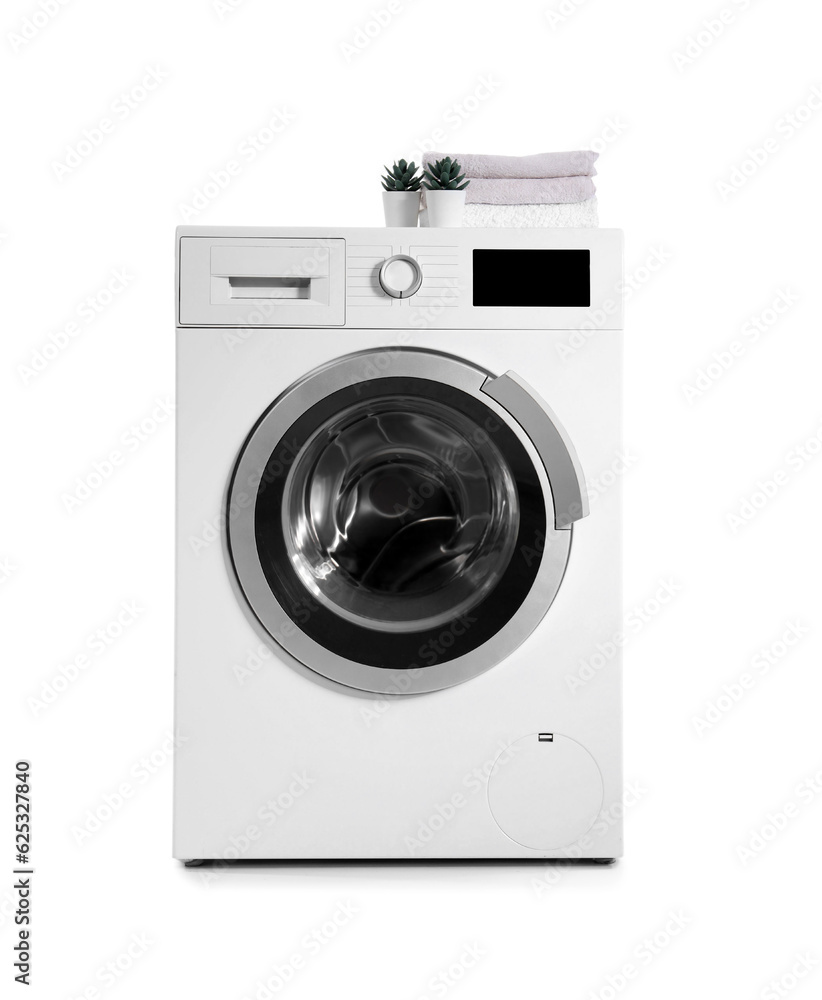 Washing machine with folded towels and houseplants isolated on white background