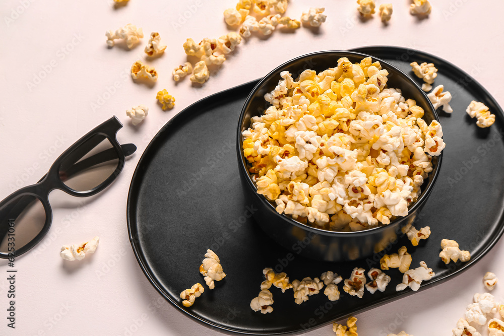 Bowl with tasty popcorn and 3D glasses on white background