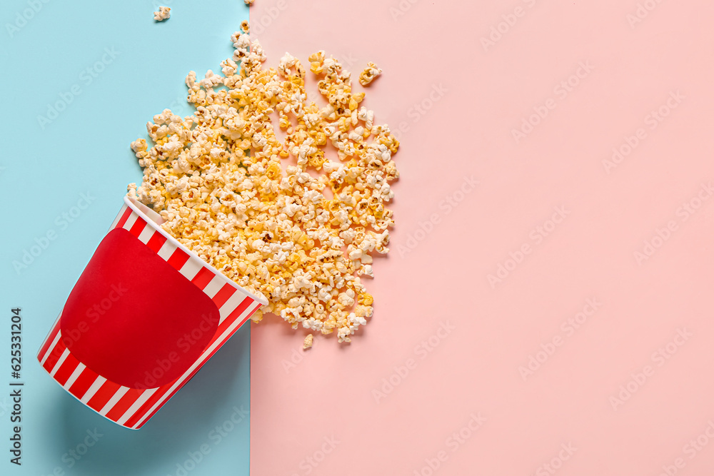 Bucket with tasty popcorn on colorful background