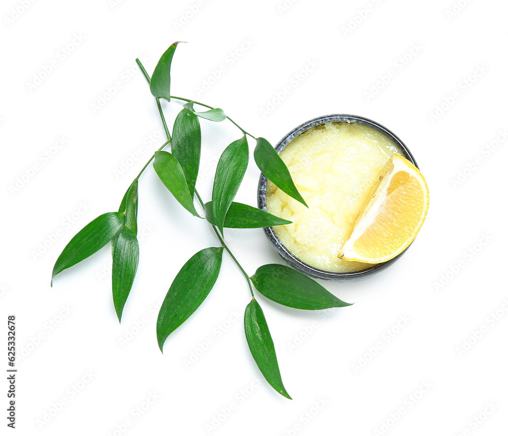 Bowl of lemon body scrub with plant branch isolated on white background