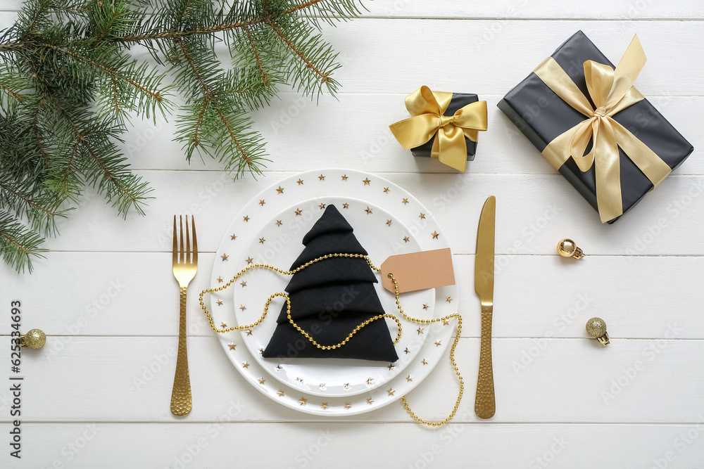 Beautiful table setting for Christmas celebration on white wooden background