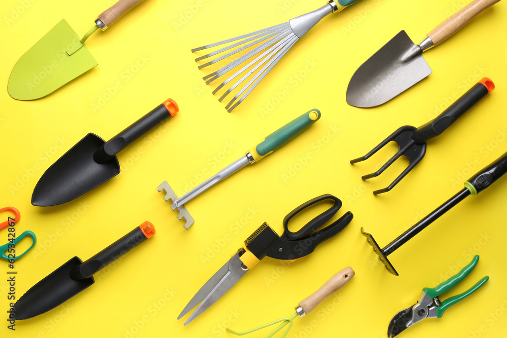 Set of different gardening tools on yellow background