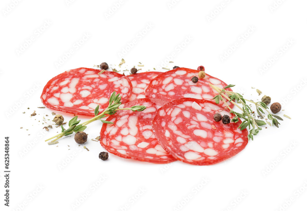 Slices of tasty salami with spices on white background