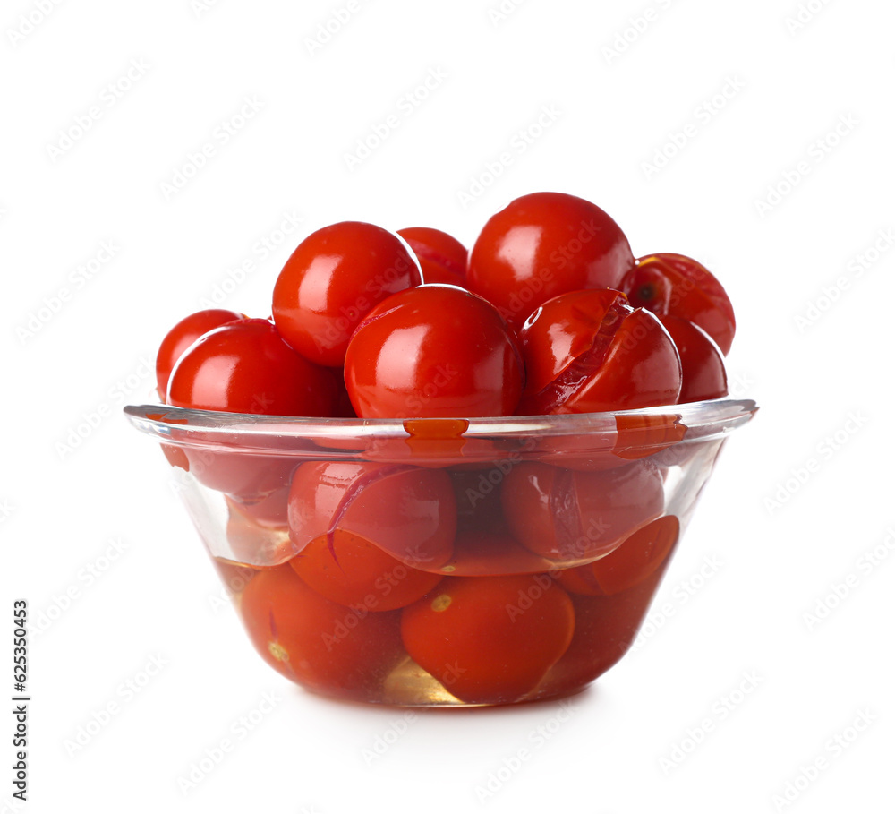 Glass bowl with canned tomatoes on white background