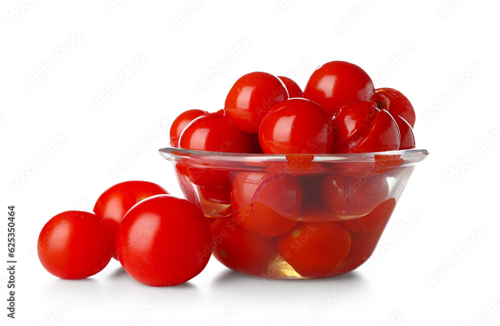 Glass bowl with canned tomatoes on white background