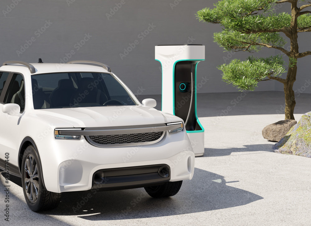 Close-up view of a White Electric Pickup Truck connected to charging station with Japanese Zen garde