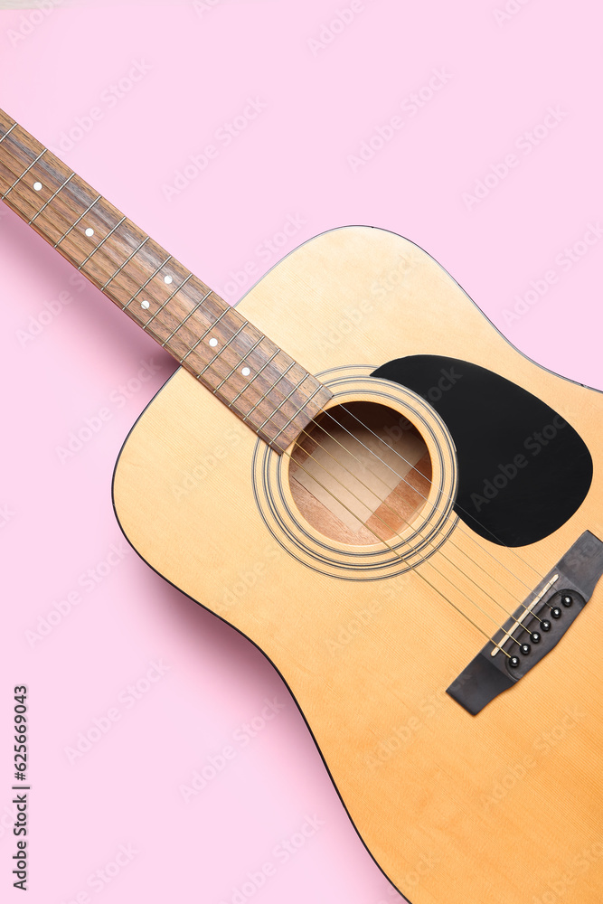 Acoustic guitar on color background