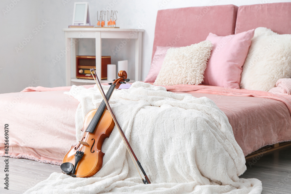 Interior of modern bedroom with violin