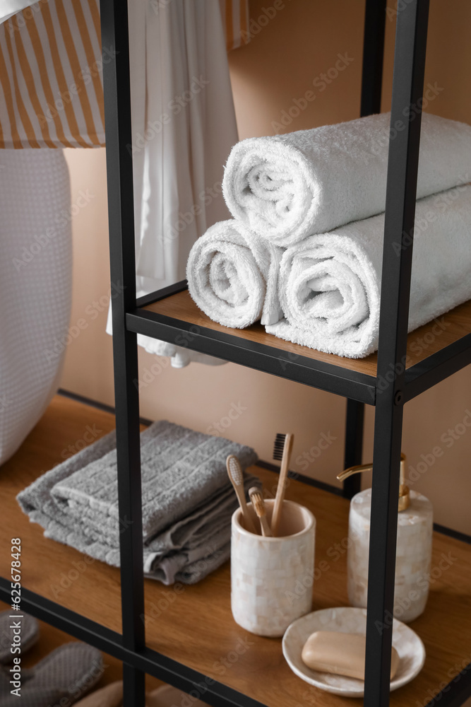 Bath accessories on shelves in room, closeup