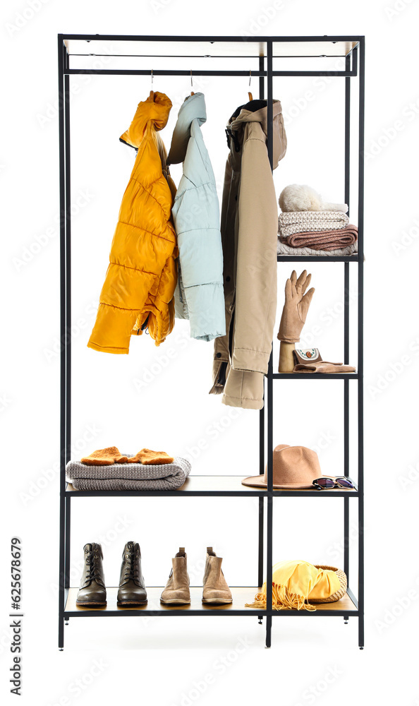 Shelving unit with clothes and accessories on white background