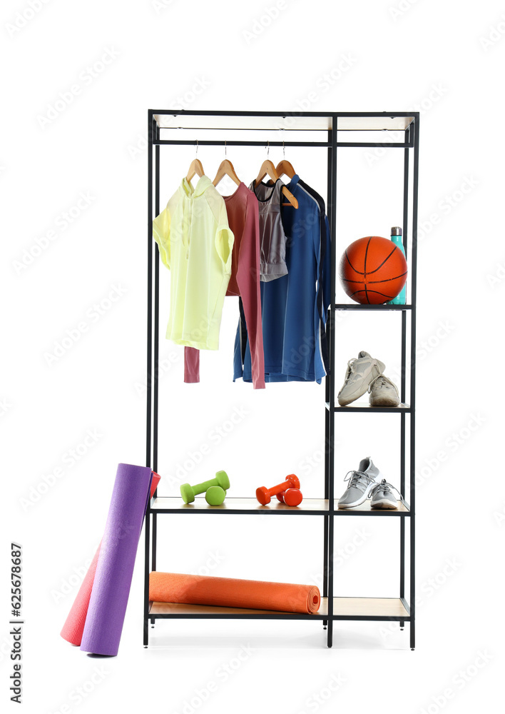 Shelving unit with sportswear and equipment on white background