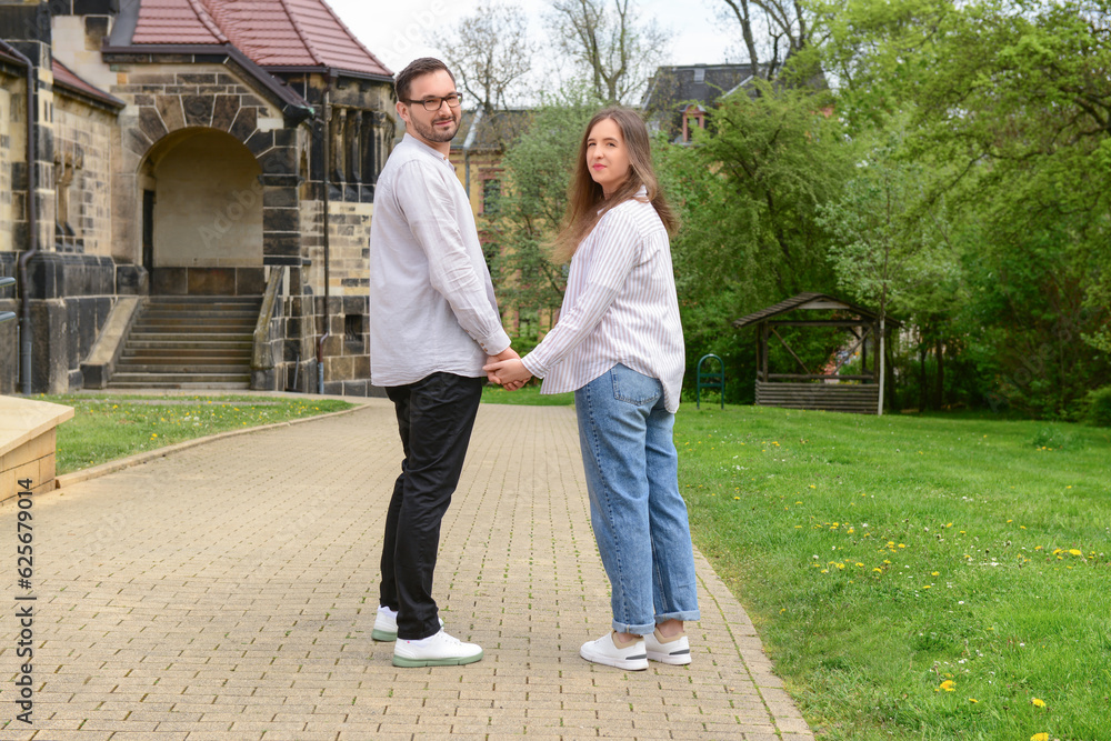 Beautiful happy couple walking in city on spring day