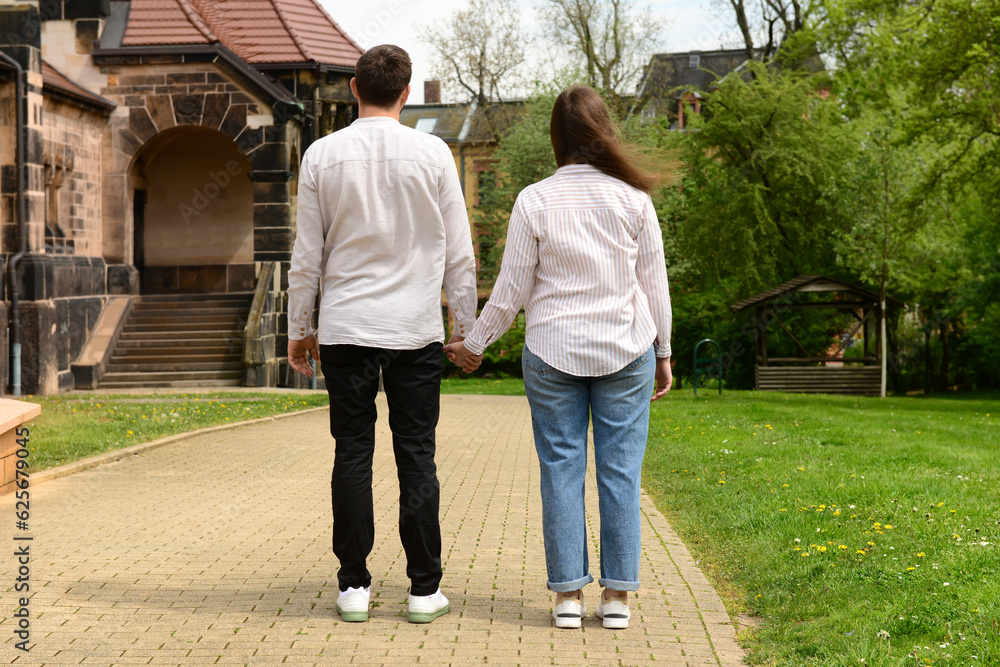 Beautiful happy couple walking in city on spring day