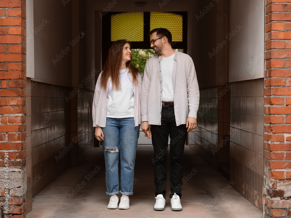 Beautiful loving happy couple walking in city on spring day