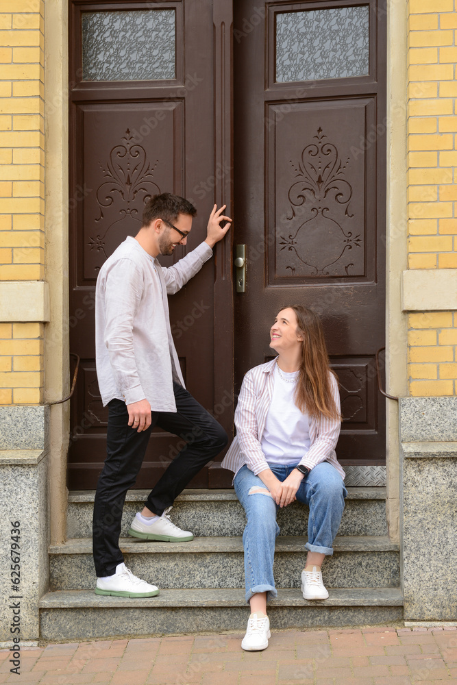 Beautiful loving happy couple walking in city on spring day