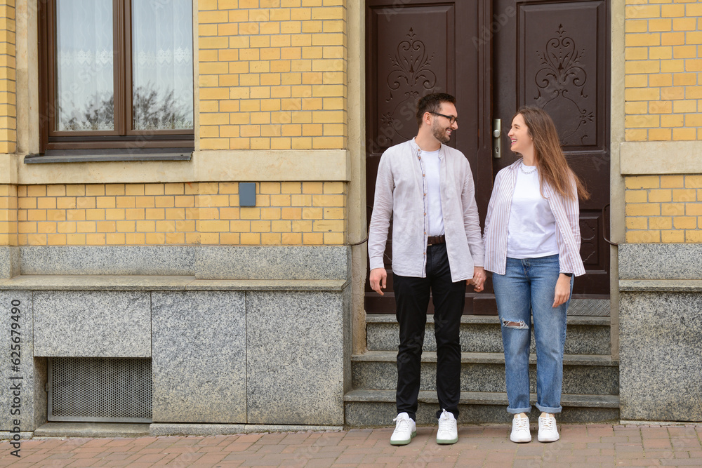 Beautiful loving happy couple walking in city on spring day