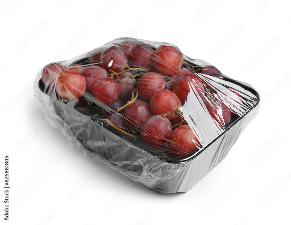 Plastic package with ripe red grapes on white background