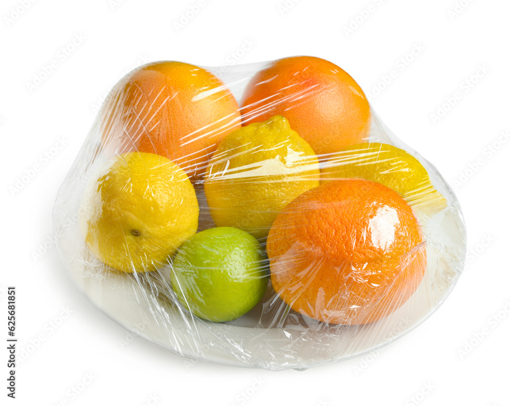 Plastic food wrap with different citrus fruits on white background