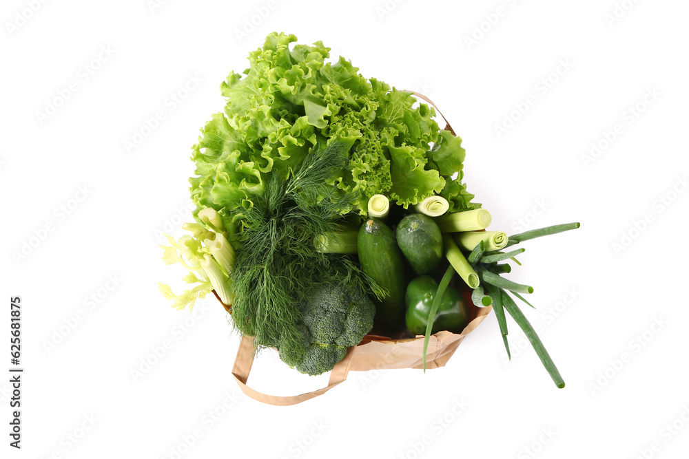 Paper bag with fresh vegetables on white background. Healthy food concept