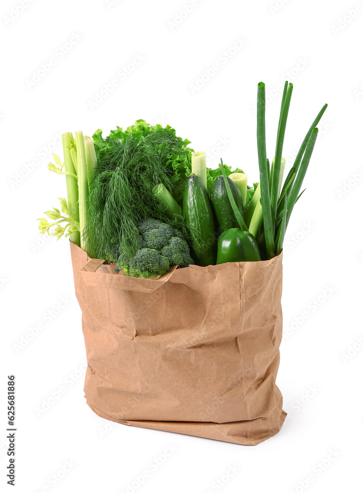 Paper bag with fresh vegetables on white background. Healthy food concept