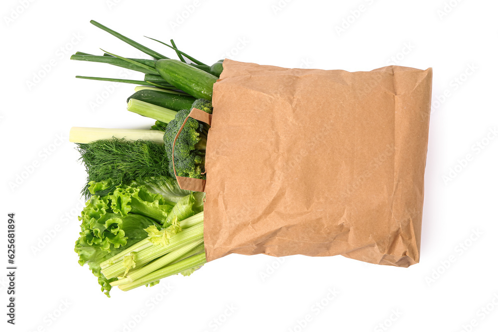 Paper bag with fresh vegetables on white background. Healthy food concept