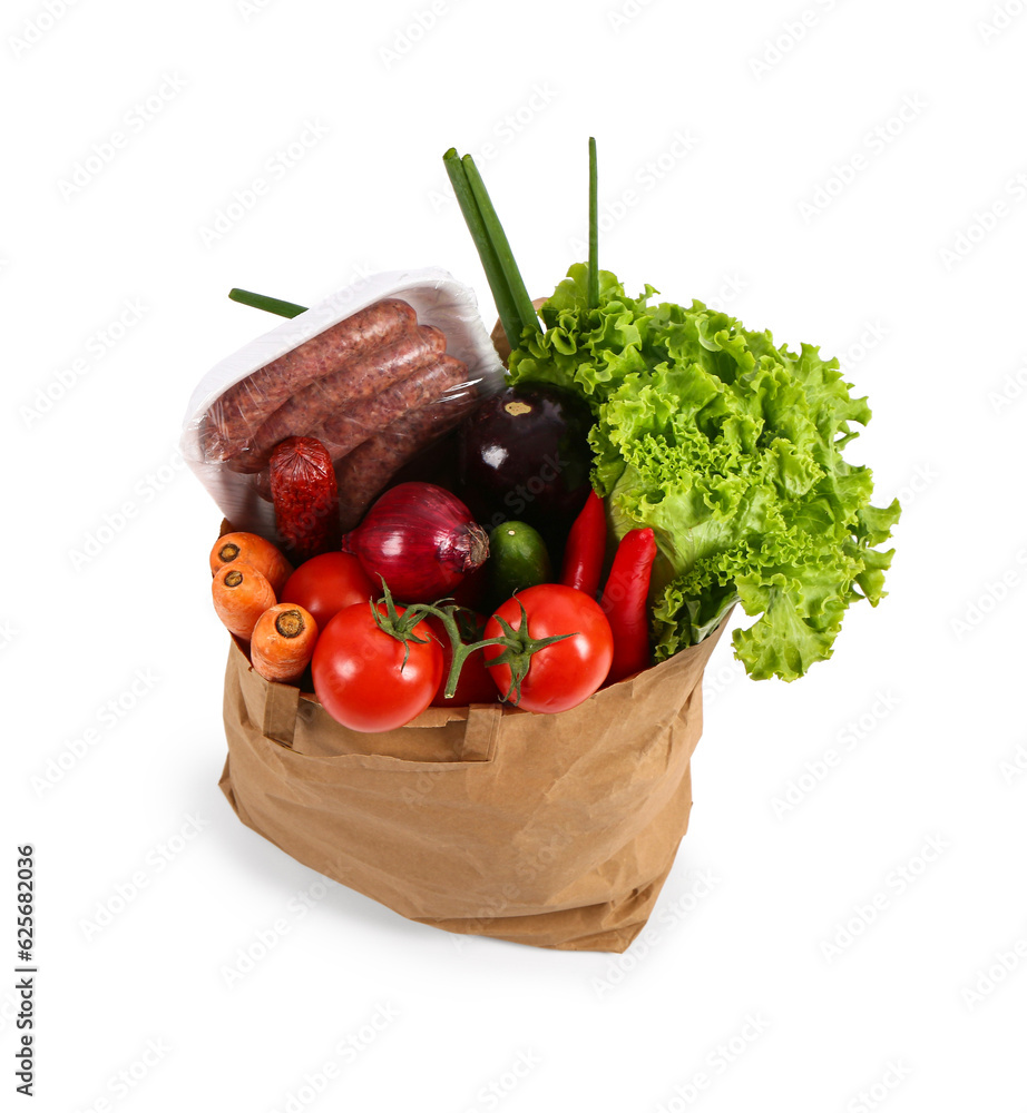 Paper bag with different fresh vegetables and sausages on white background