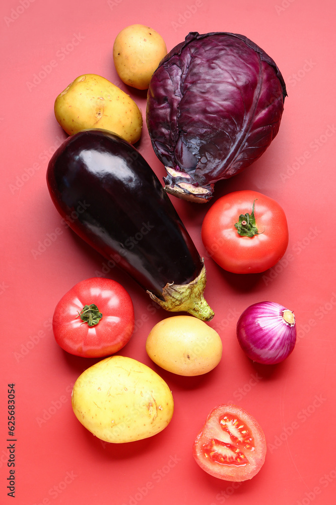 Different fresh vegetables on red background