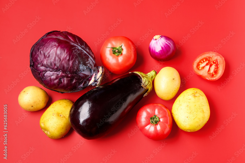 Different fresh vegetables on red background