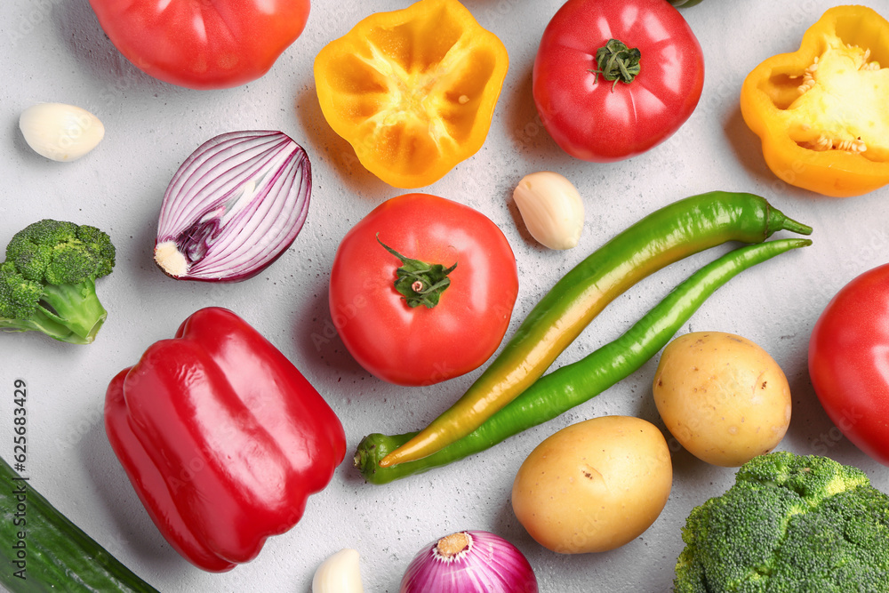 Different fresh vegetables on grey background