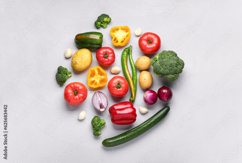 Different fresh vegetables on grey background