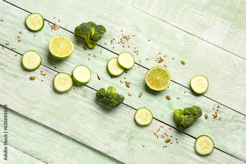 Different healthy products on green wooden background