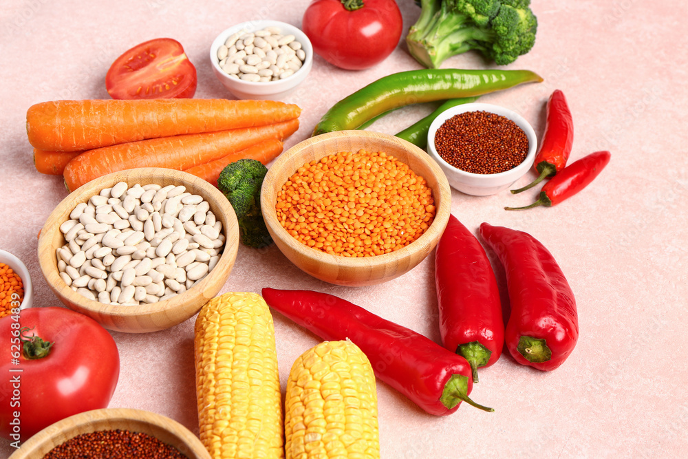 Different fresh vegetables and cereals on pink background, closeup