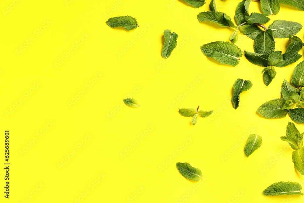 Composition with fresh mint leaves on yellow background