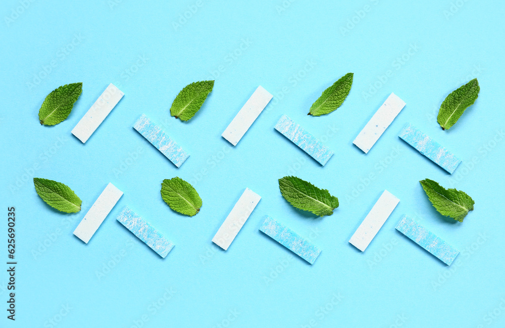 Fresh chewing gums with mint on blue background