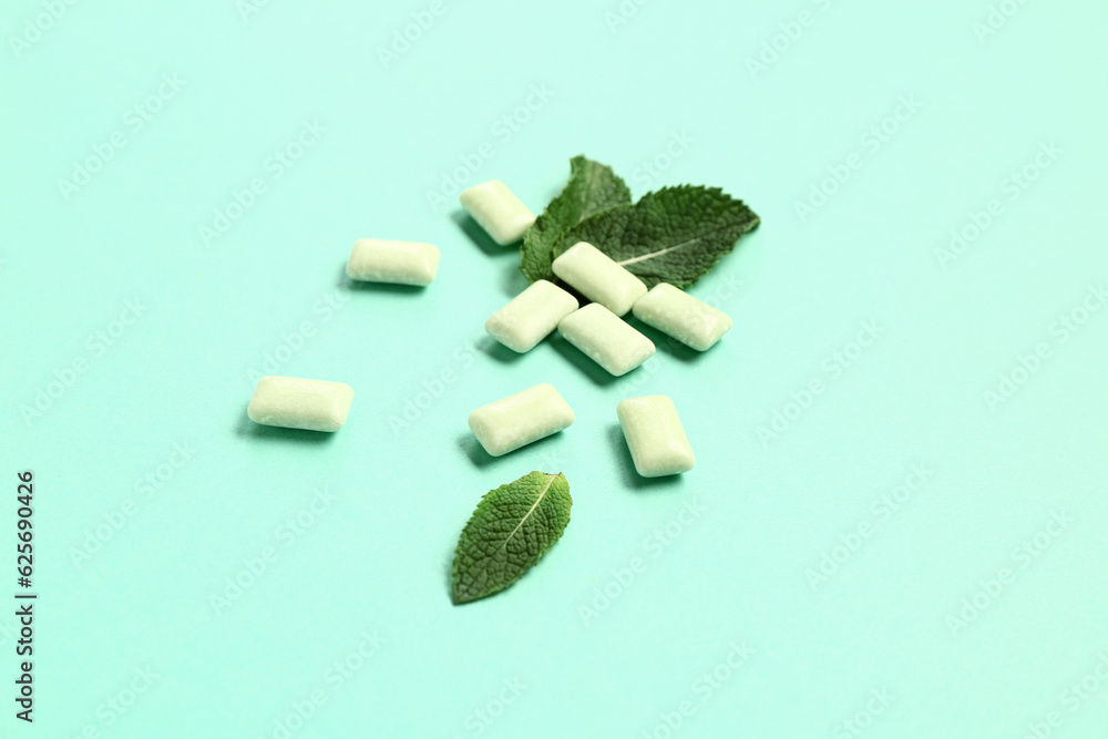 Fresh chewing gums with mint on turquoise background