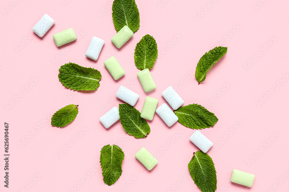 Fresh chewing gums with mint on pink background