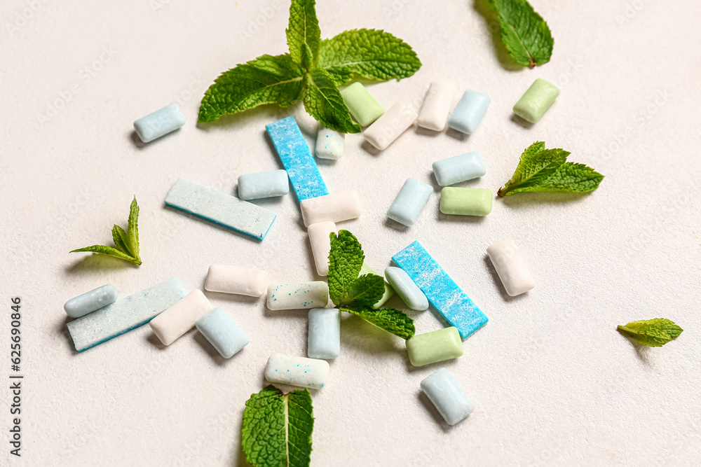 Fresh chewing gums with mint on white background