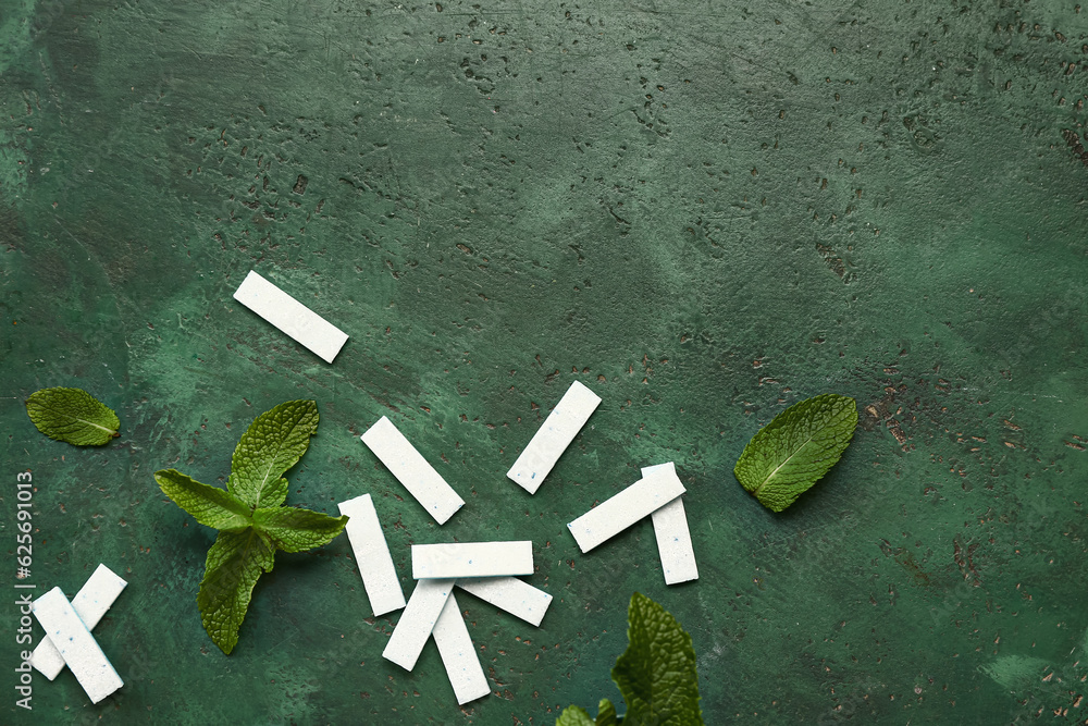 Fresh chewing gums with mint on green background