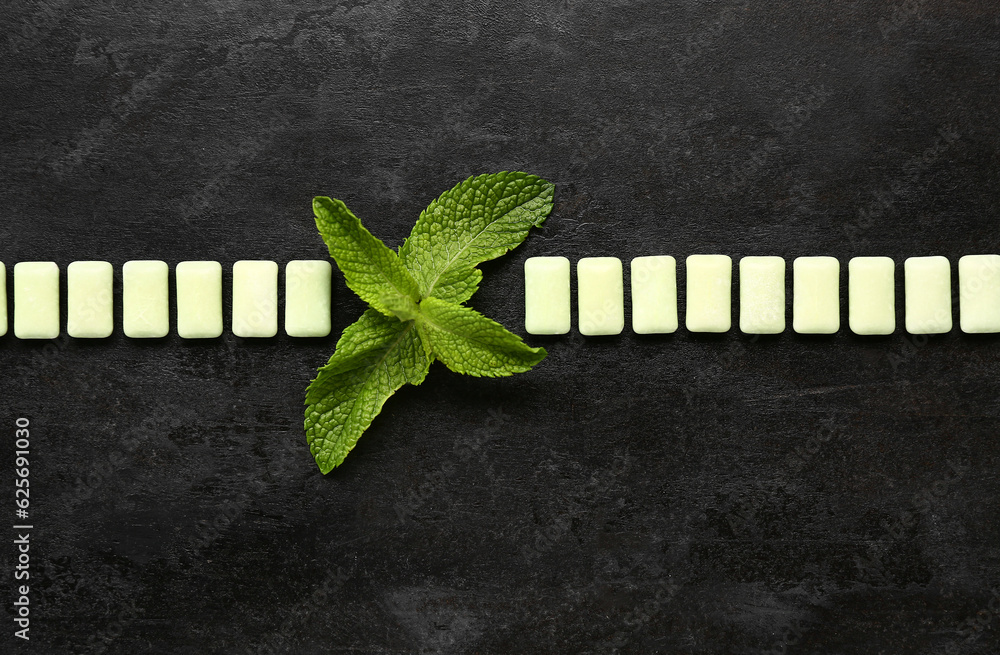 Fresh chewing gums with mint on black background