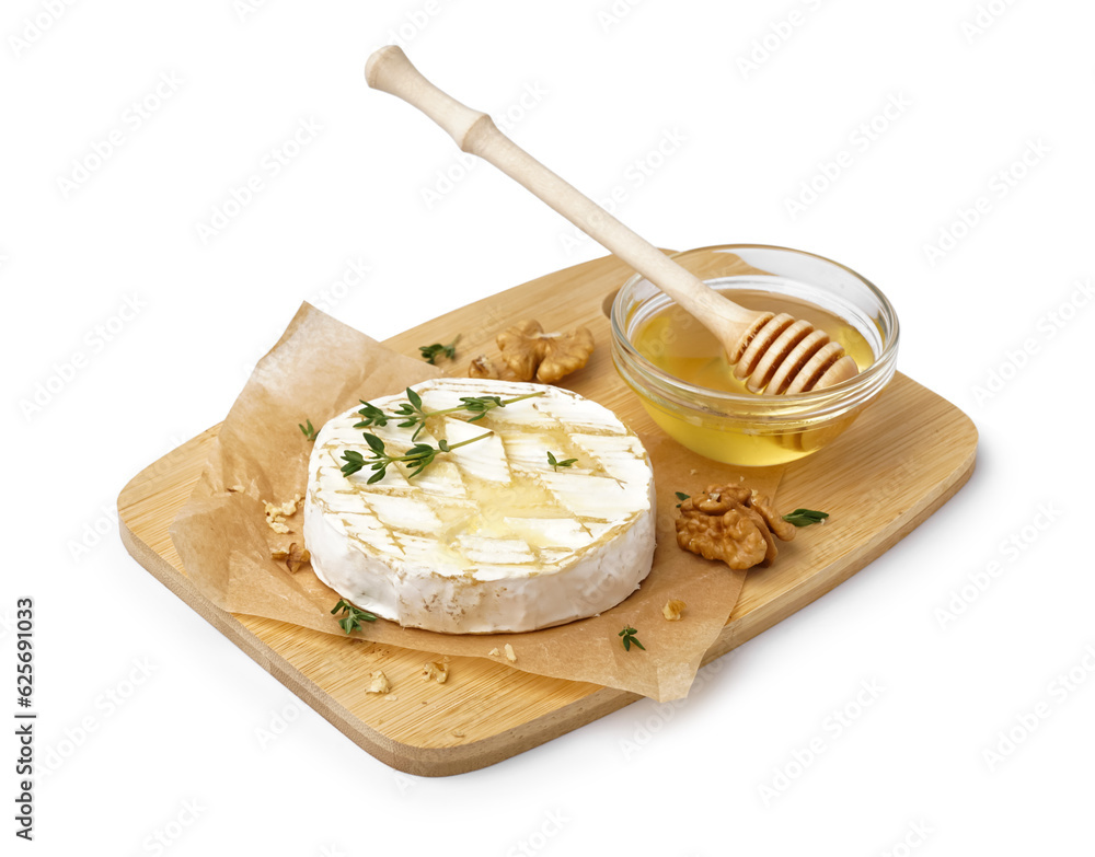 Wooden board of tasty baked Camembert cheese with honey on white background