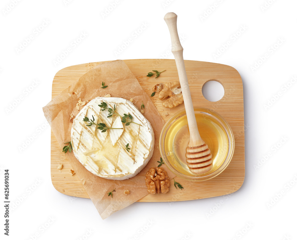 Wooden board of tasty baked Camembert cheese with honey on white background